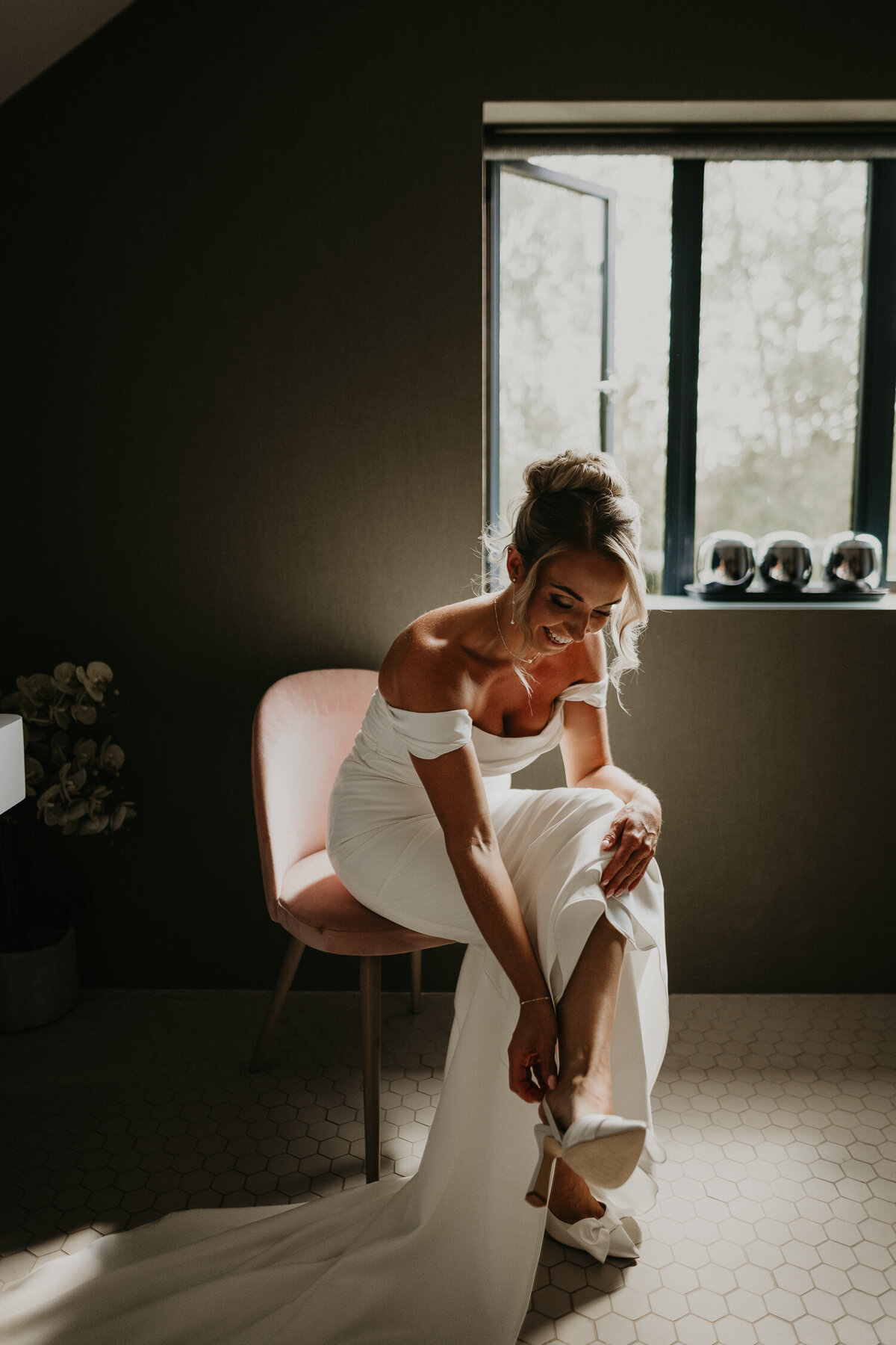 Bride putting on her shoes before her wedding at Lapstone Barn.