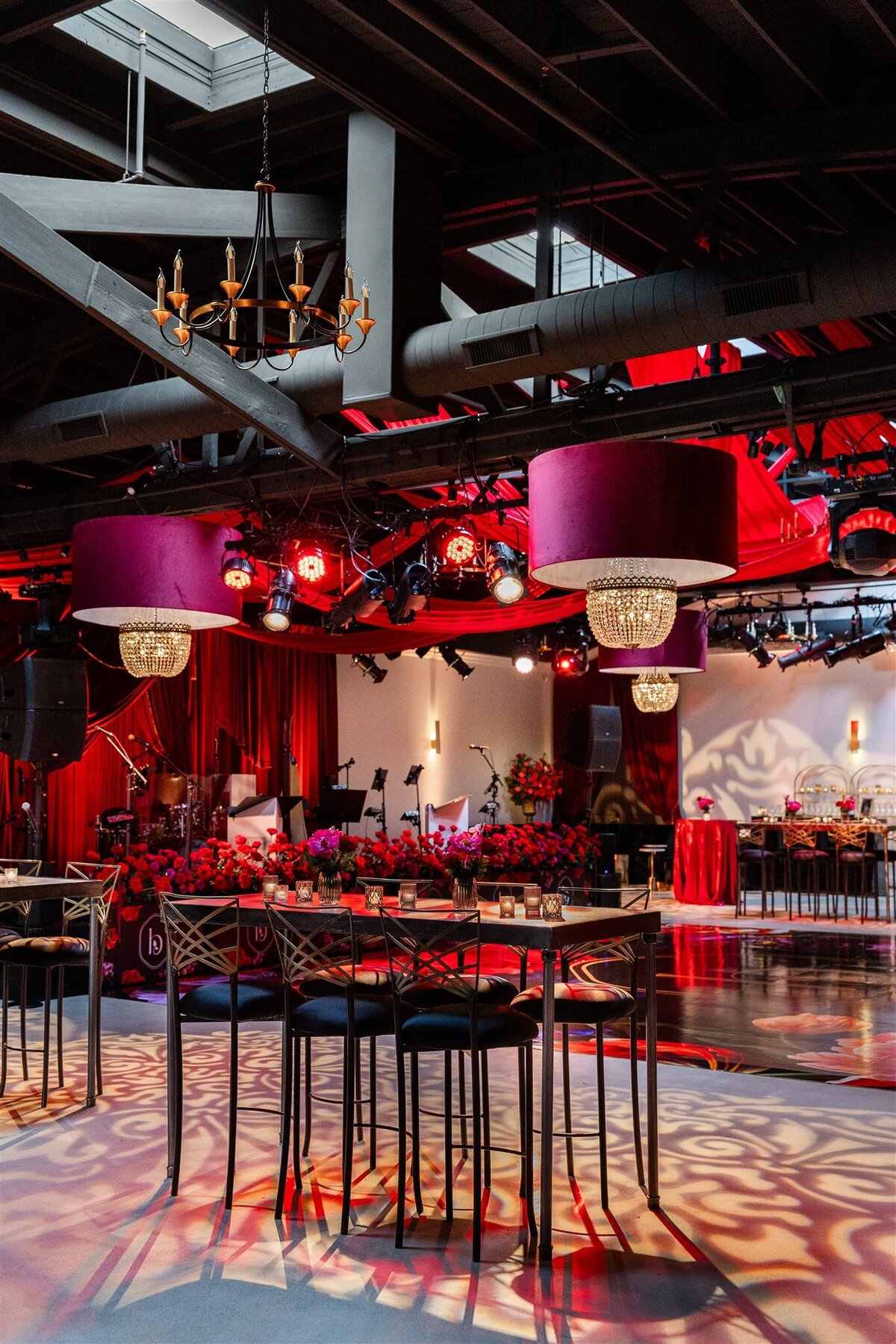 Event space styled with a Baroque theme, featuring ornate gold accents, rich fabrics, grand chandeliers, and intricate moldings, creating a luxurious and dramatic atmosphere