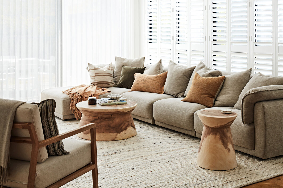 Hampton East open-plan living room styled with neutral tones and timber details