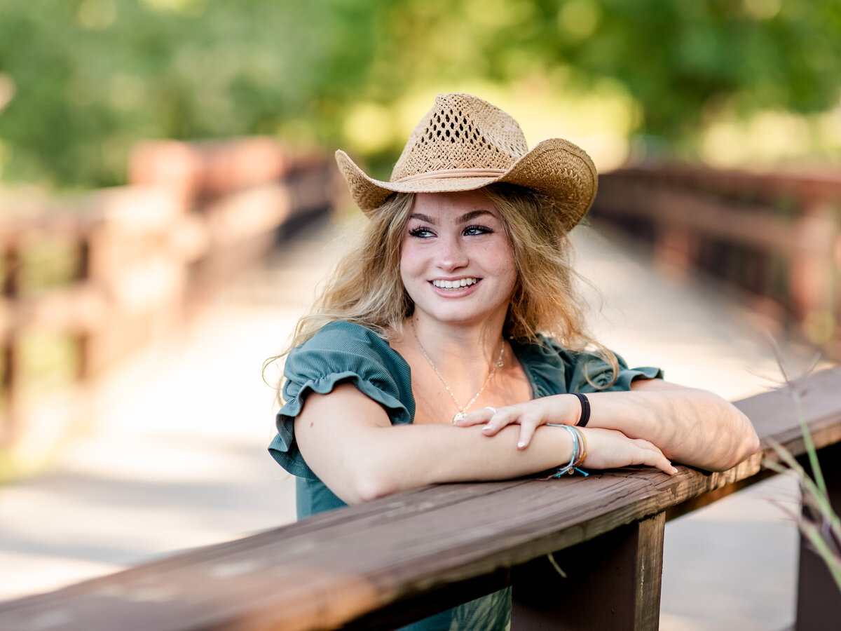 high school senior girl wearing cowboy hat for senior portraits at westcreek reservation in parma ohio
