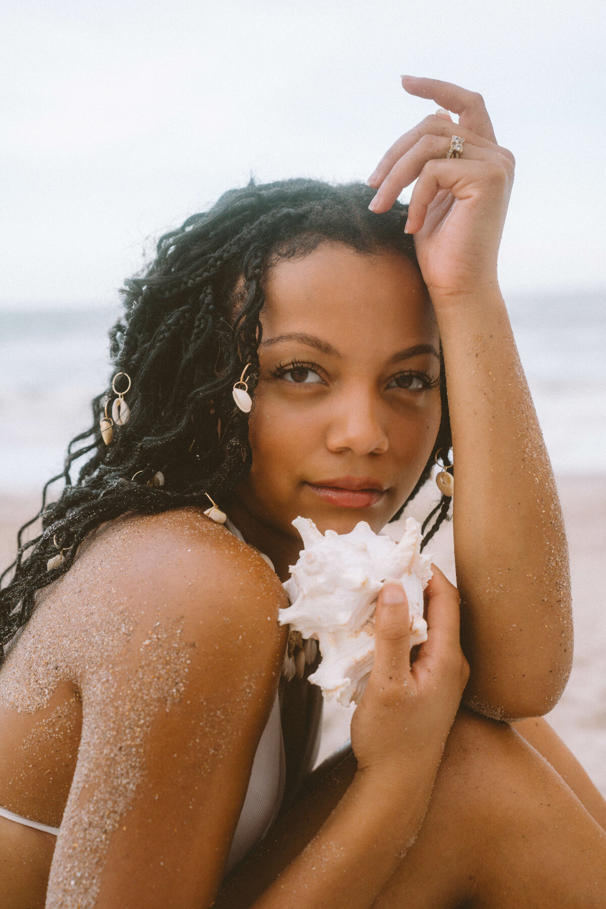 Girl holding shell on beach