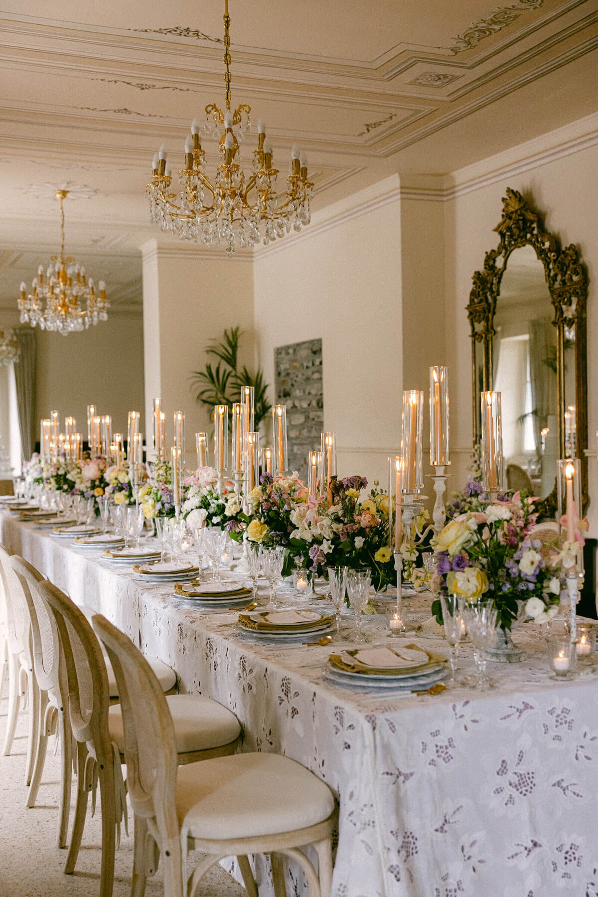 A wedding day photo of the reception cable covered in linens and candles at the wedding venue Villa Aura del Lago on Lake Como in Italy
