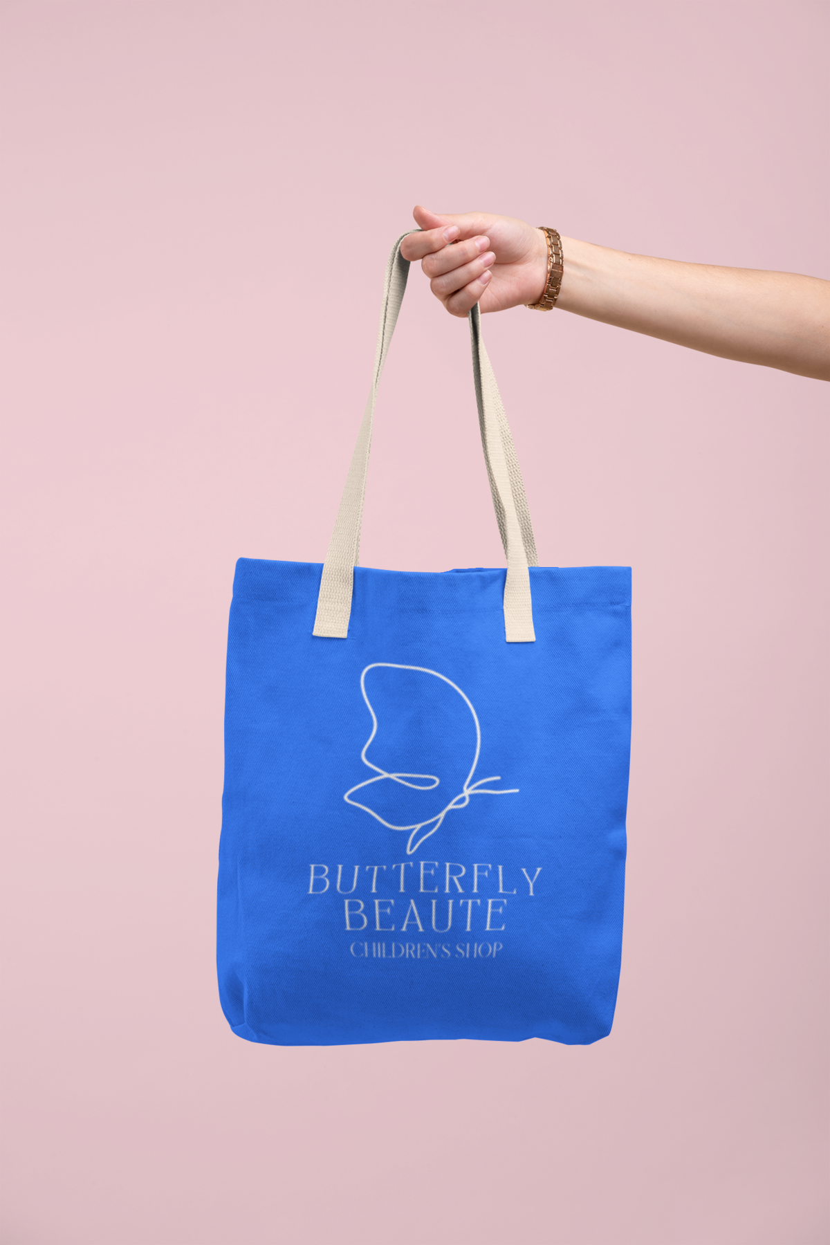 tote-bag-mockup-being-held-by-a-hand-against-a-flat-surface-28830