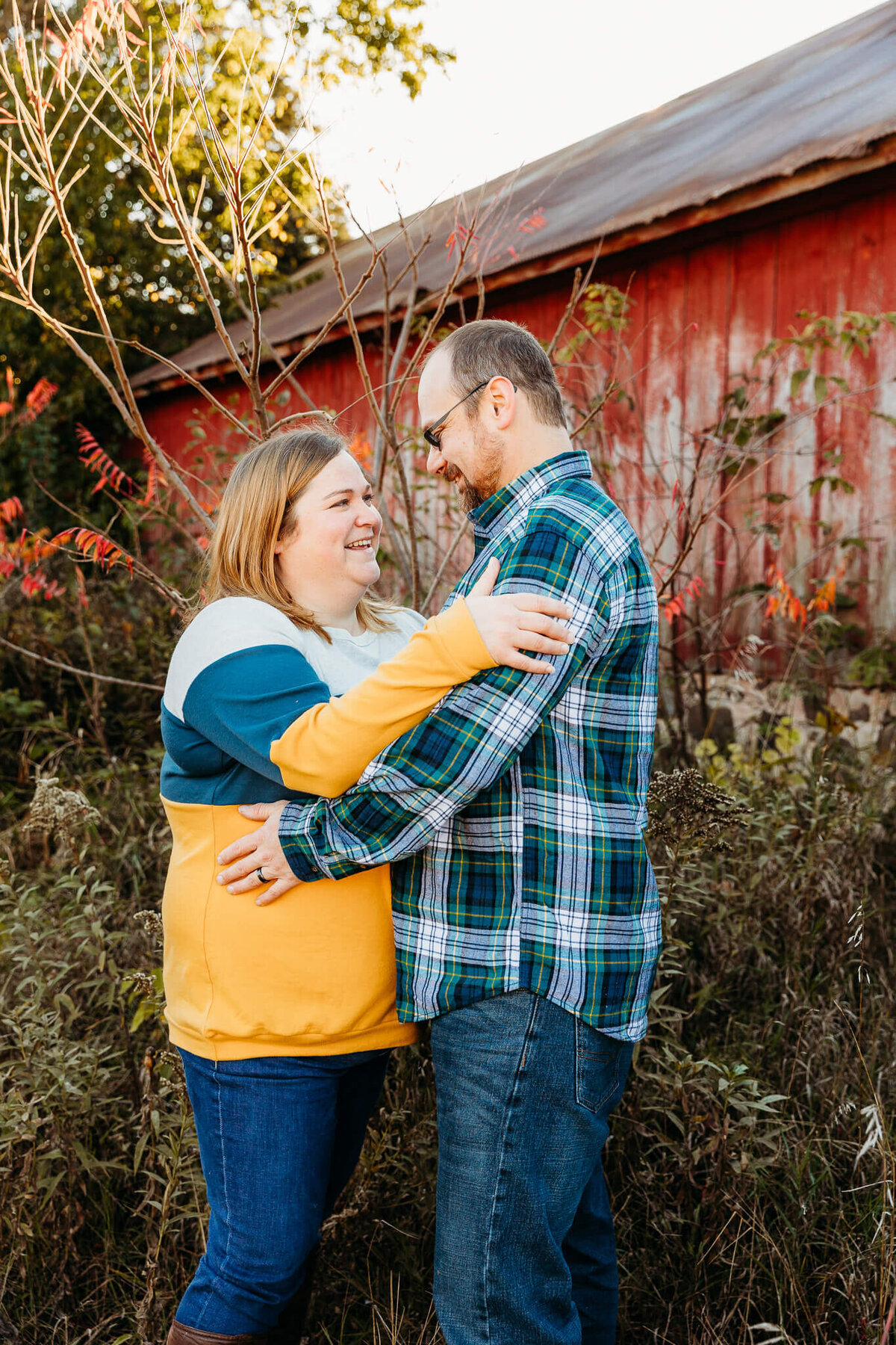 Beautiful couple laughing with each other at a rustic location for photo session