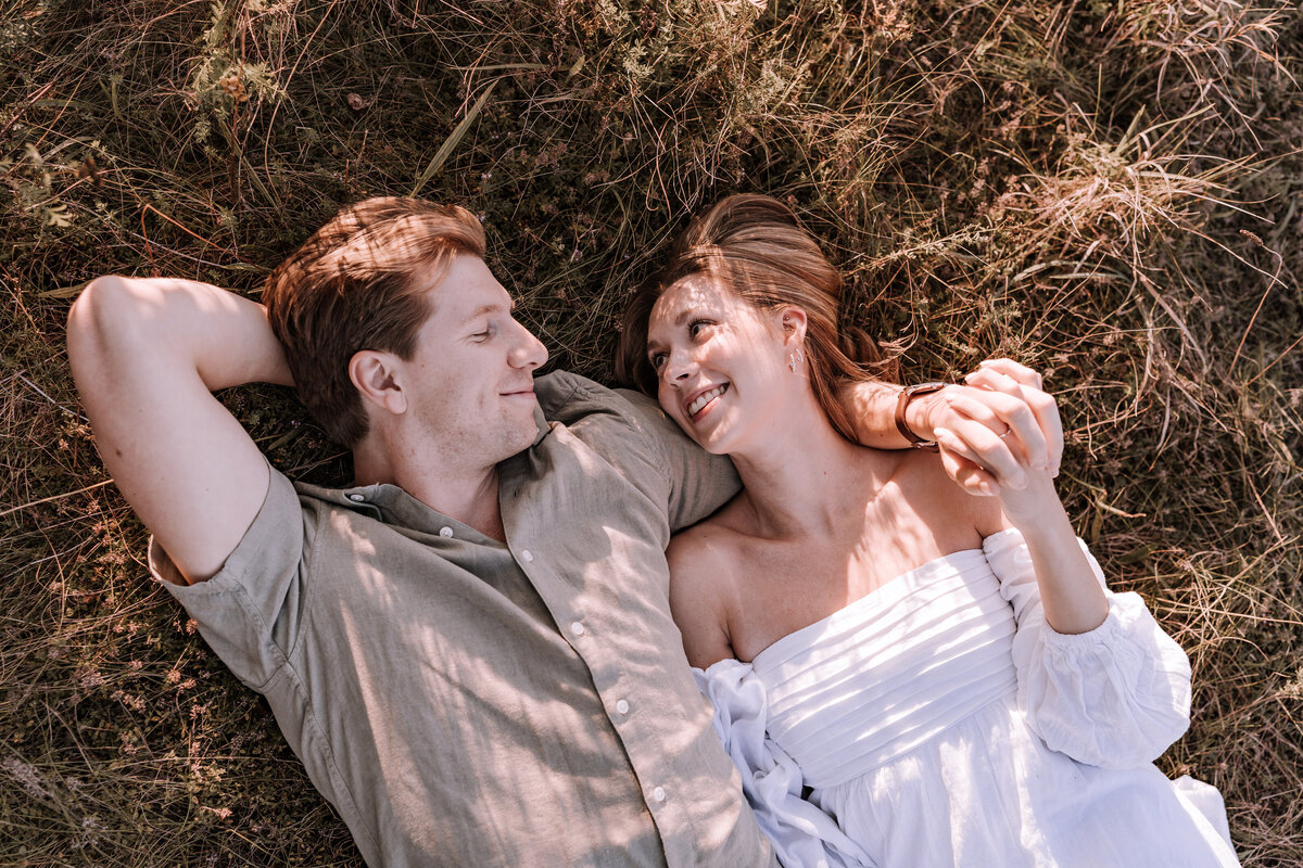 Couple laying in grass