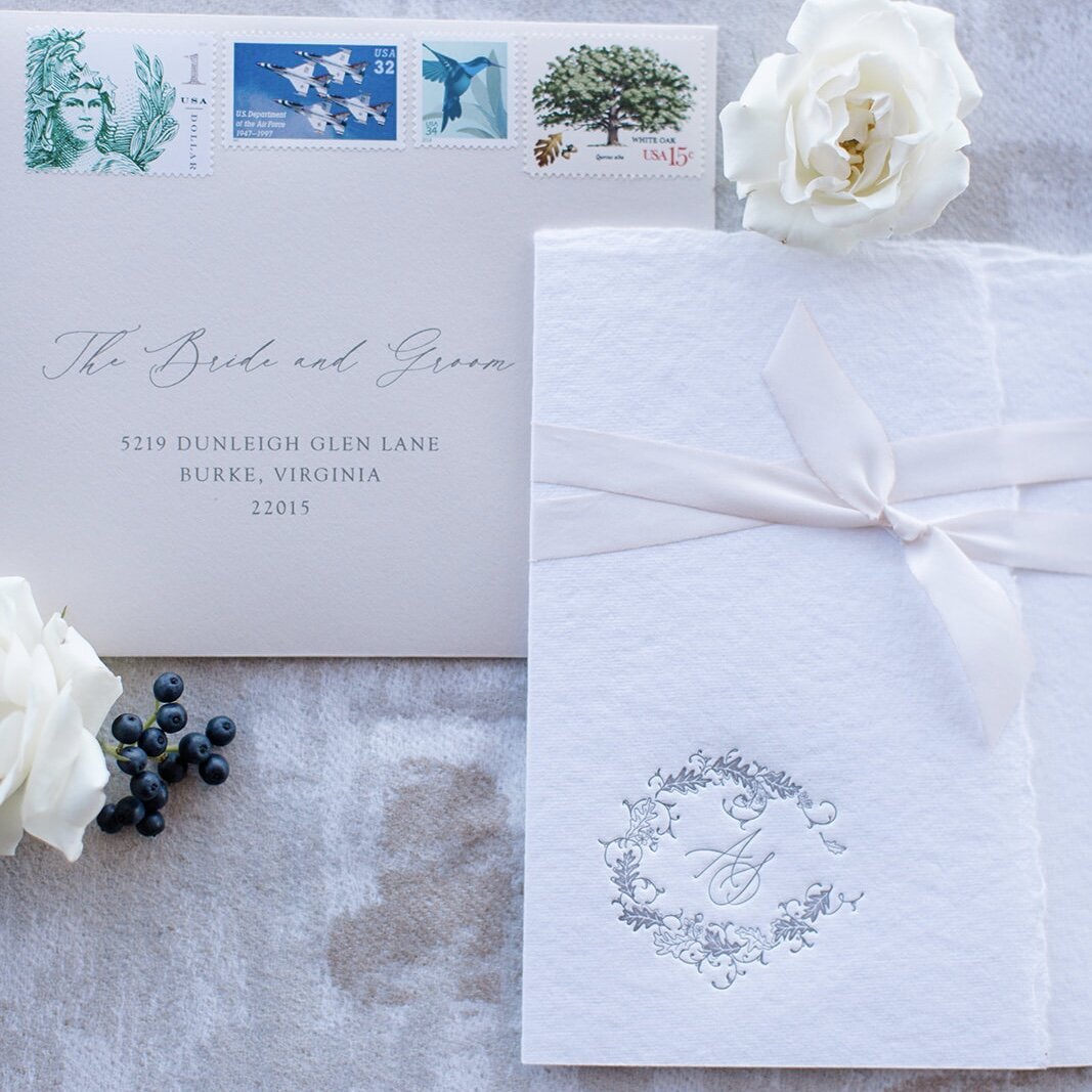 Clean white wedding invitation and envelope with custom calligraphy