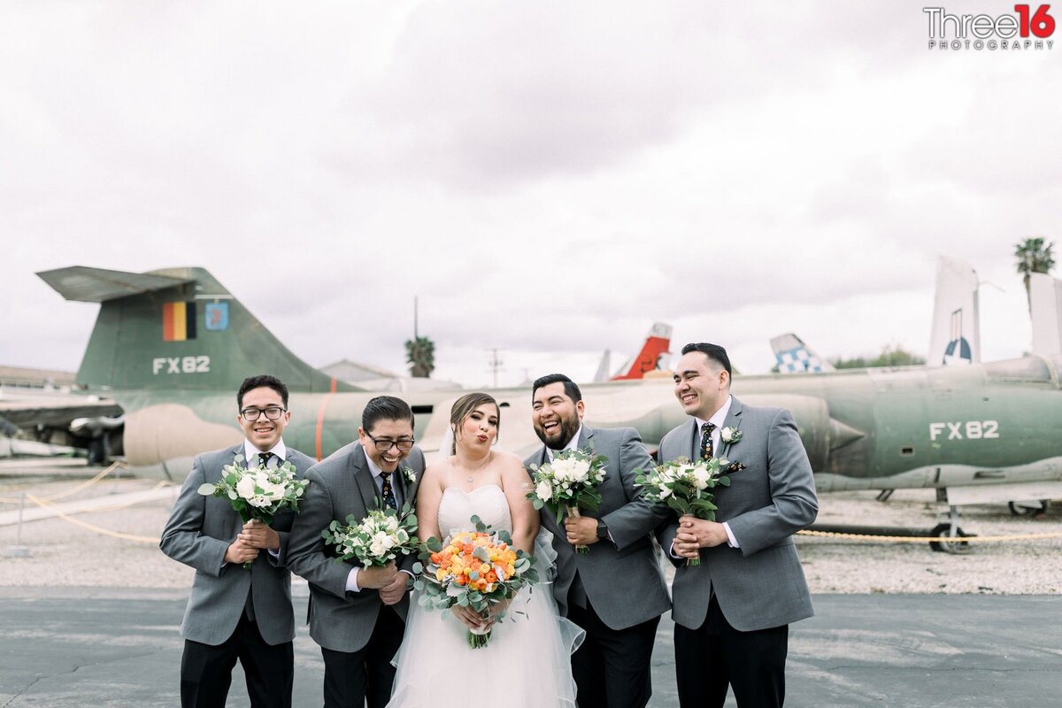Bride and the Groomsmen pose in a silly manner