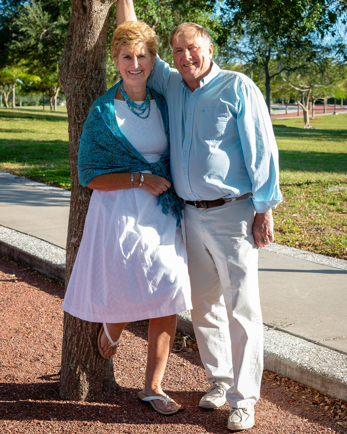 An elderly couple poses for a family photo at a park in Sarasota