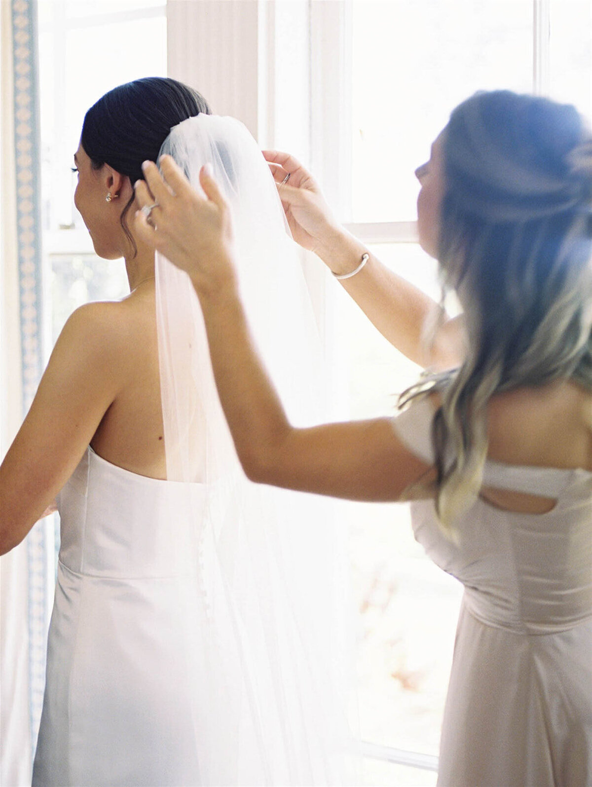Bride gets veil put on