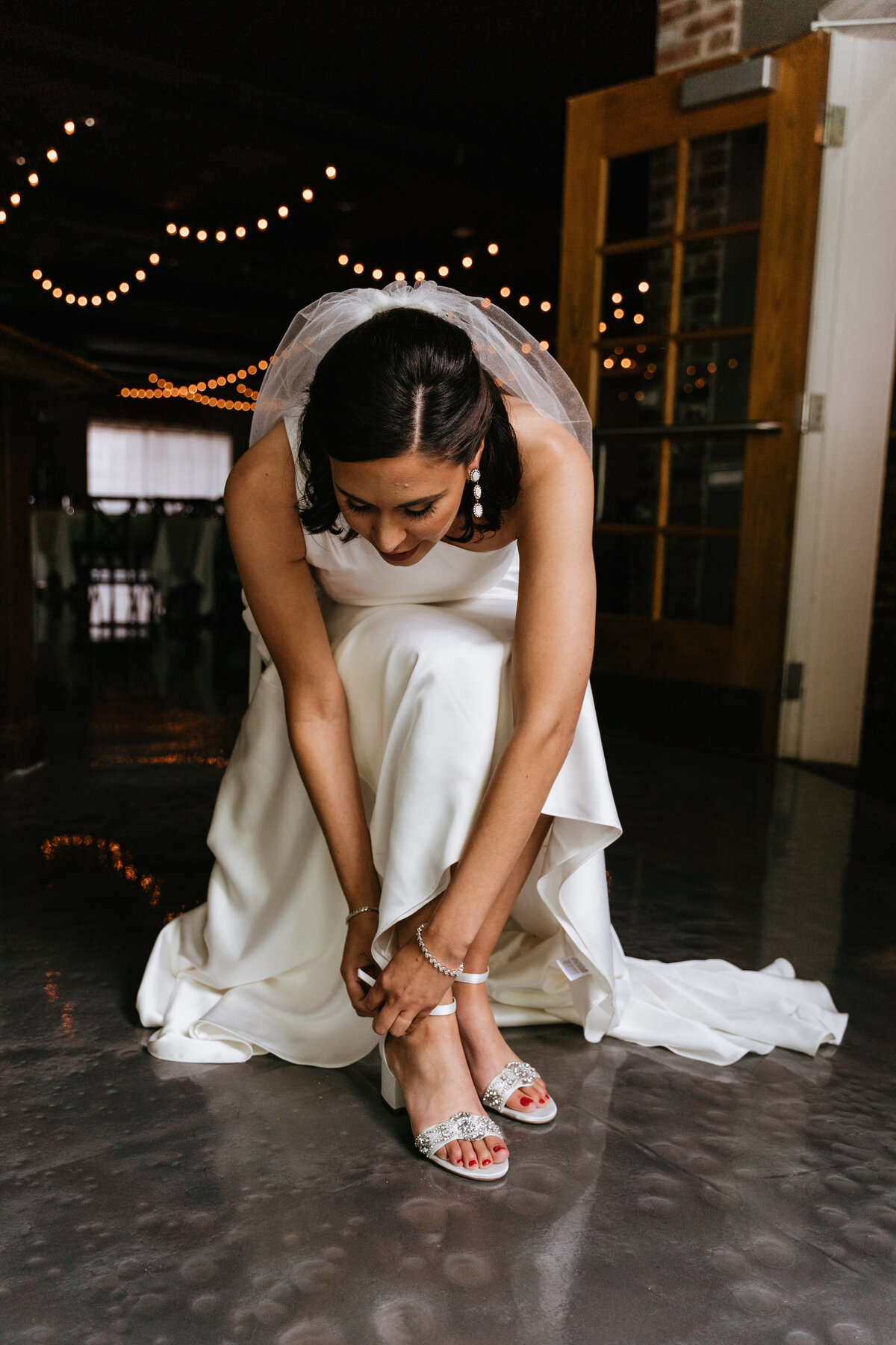 Bride adjusting shoes