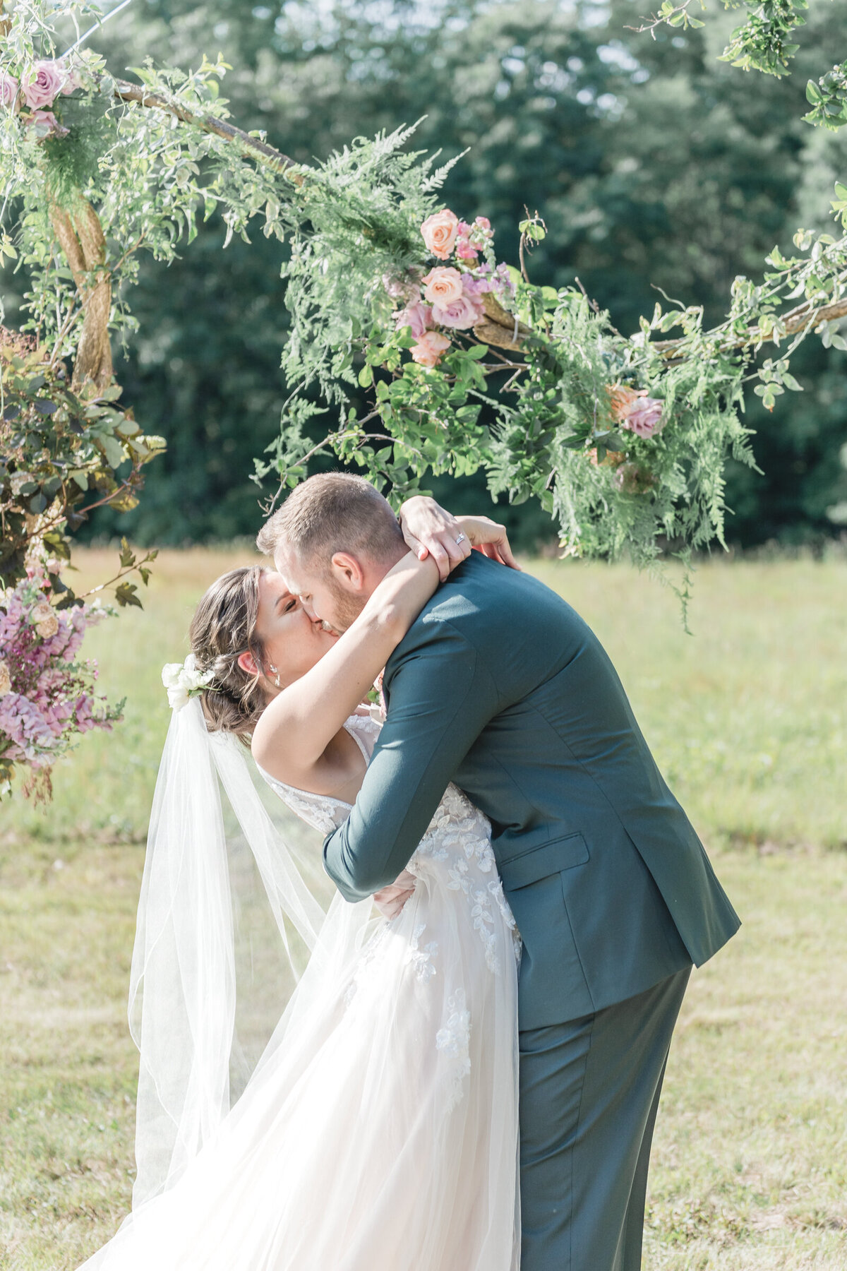 the bride and groom share their first kiss as a married couple