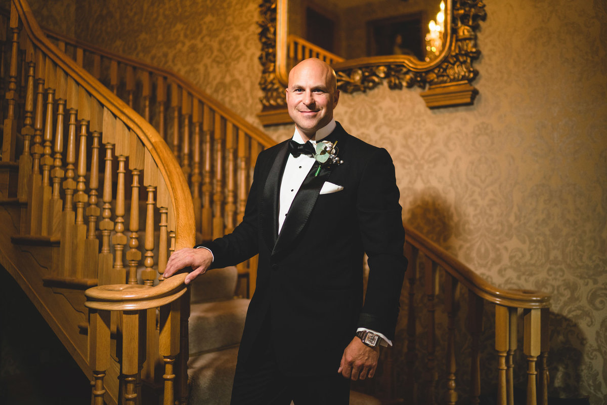 groom stood on the stairs at merrydale manor