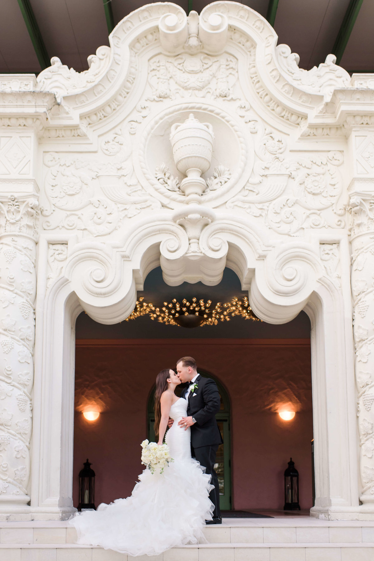 Bride and Groom kiss at the top of the elaborate stairs at the Vinoy Hotel in St. Petersburg, FL