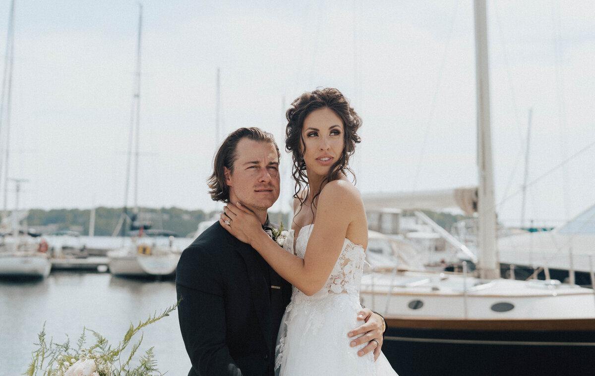 bride and groom looking at the water during their wedding in green bay wisconsin