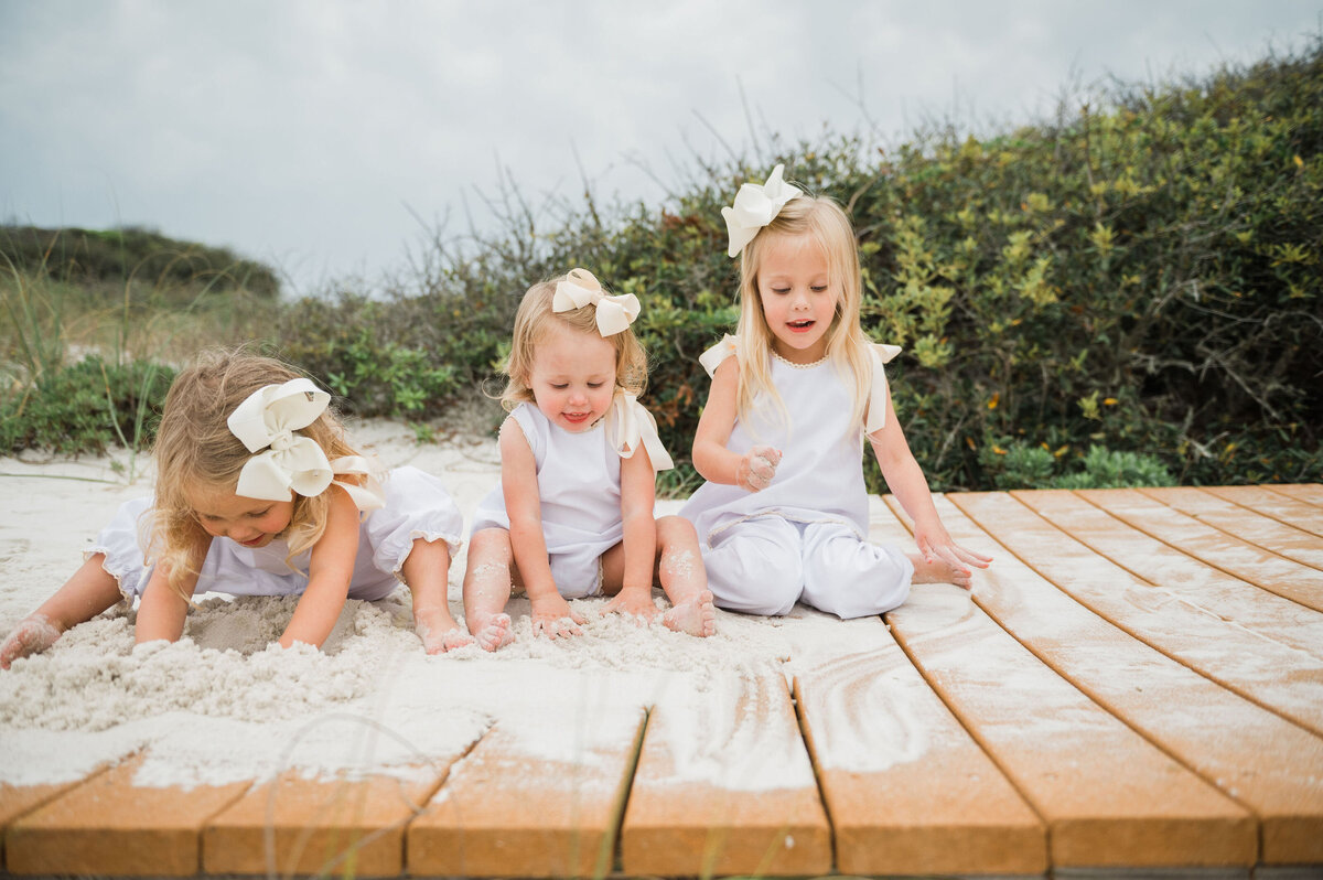 pensacola beach photo session with sisters playing on boardwalk