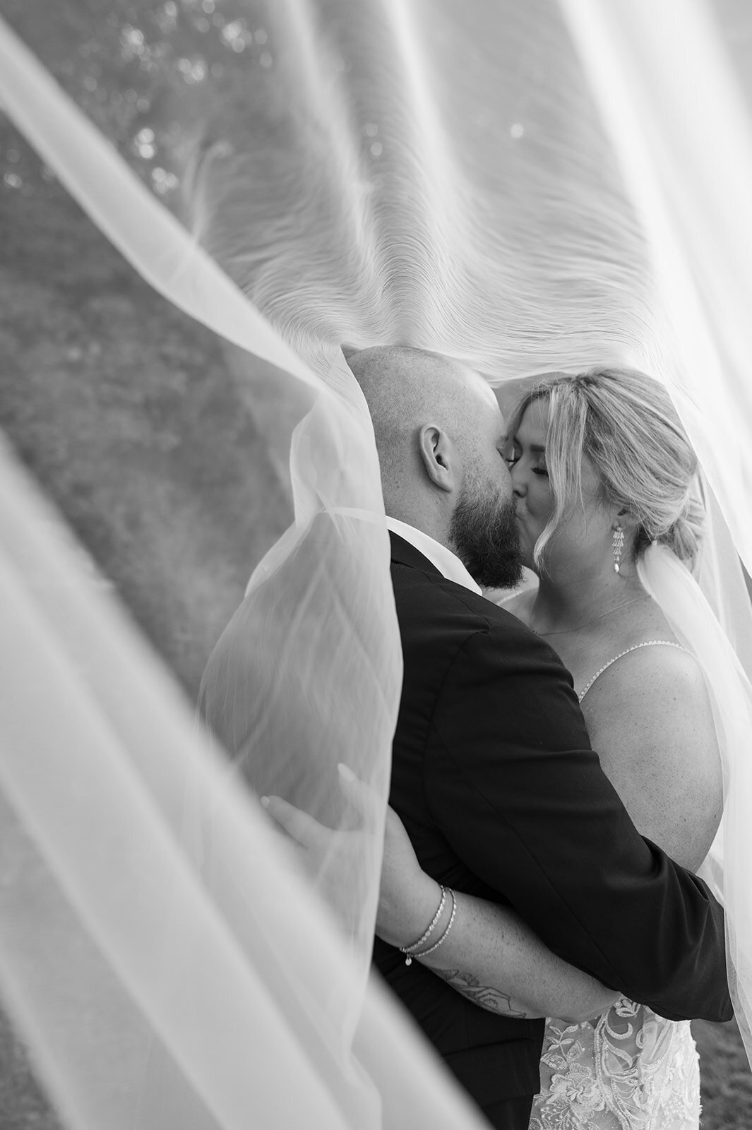 Bride-Groom-kiss-under-veil