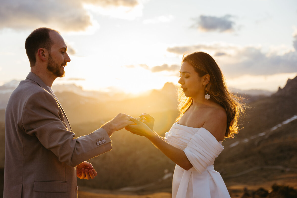 romantic couple wearing wedding ring with dramatic Dolomites backdrop