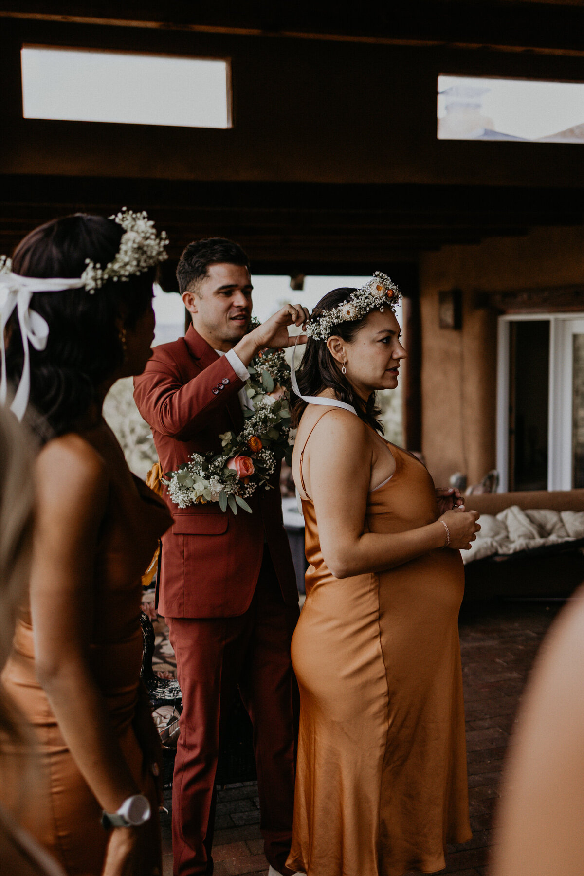 wedding party putting on flower crowns