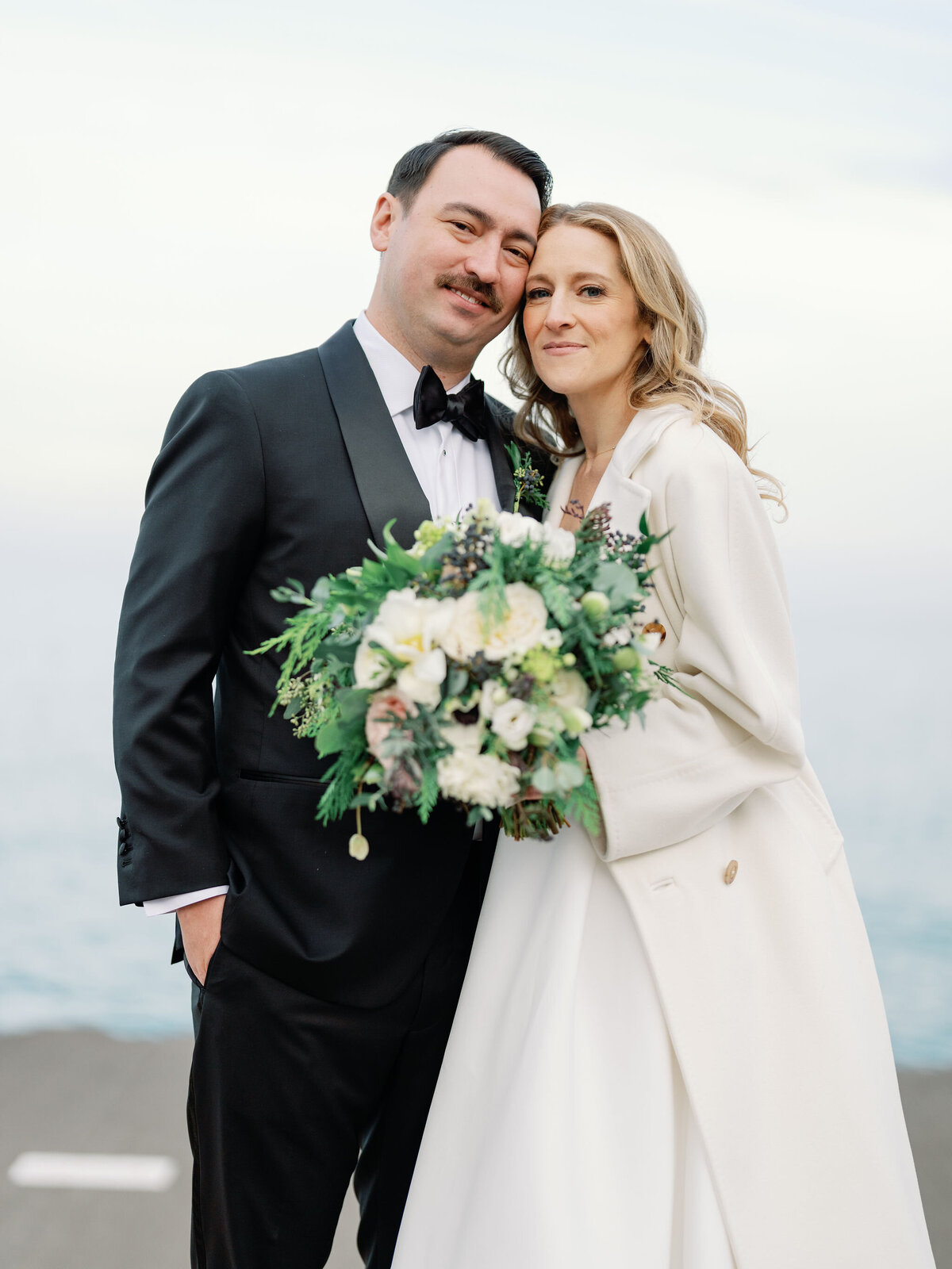The bride and groom standing together for their photo. 
