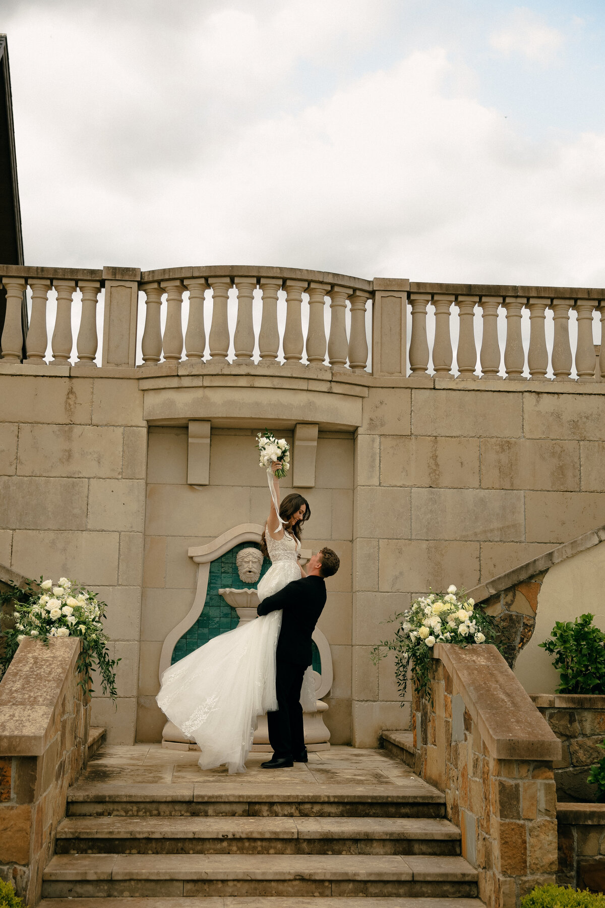 Groom Lifting Bride on Stone Steps at Elegant Oregon Venue | Romantic Wedding Portraits