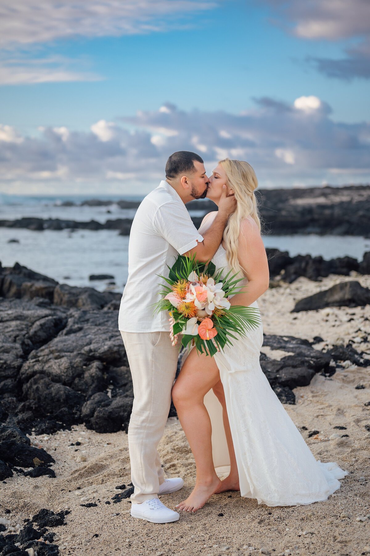 a passionate kiss between bride and groom