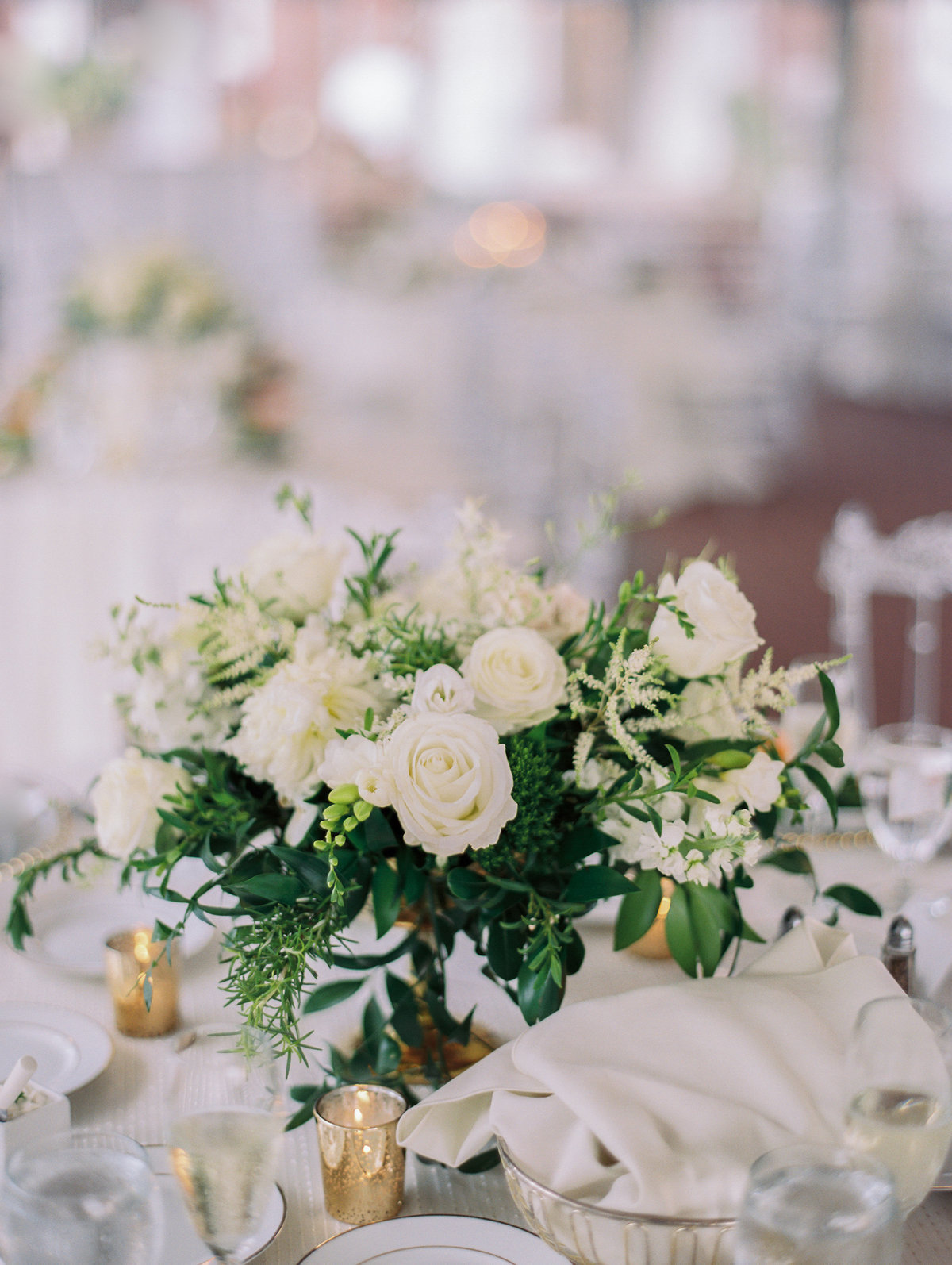 white floral arrangement for reception table centerpieces in the tent at Oxon Hill Manor