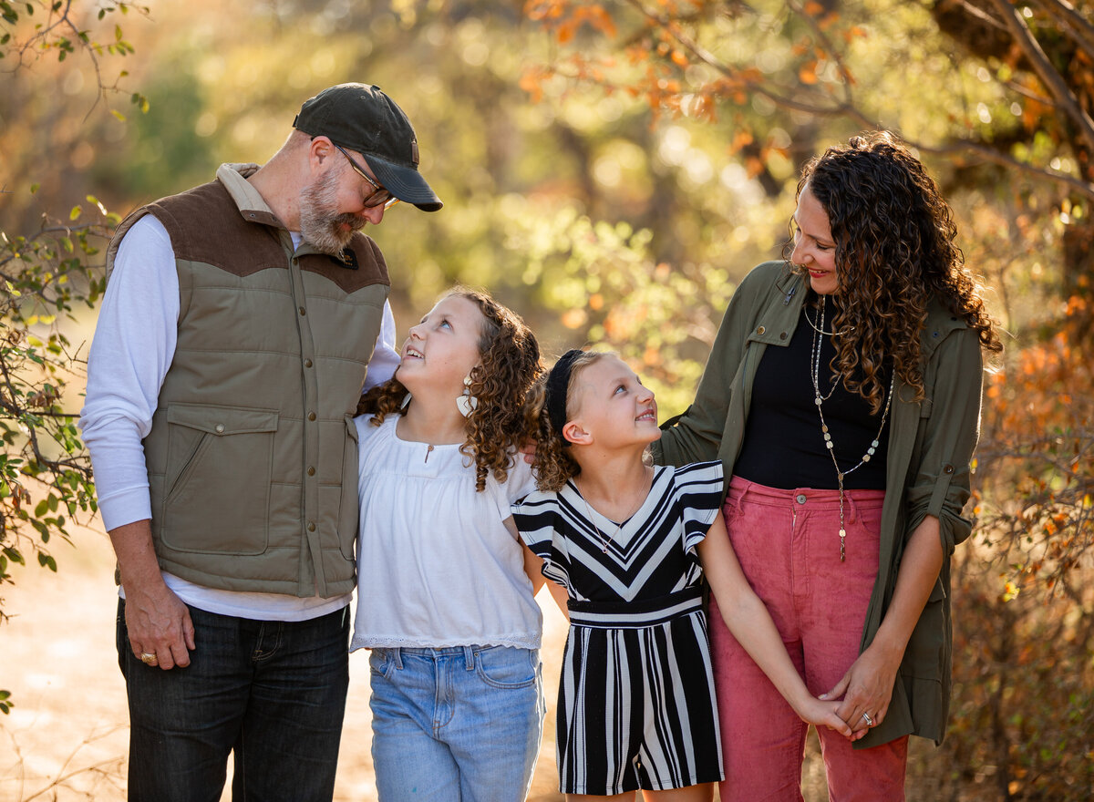 happy family looking at each other in fall