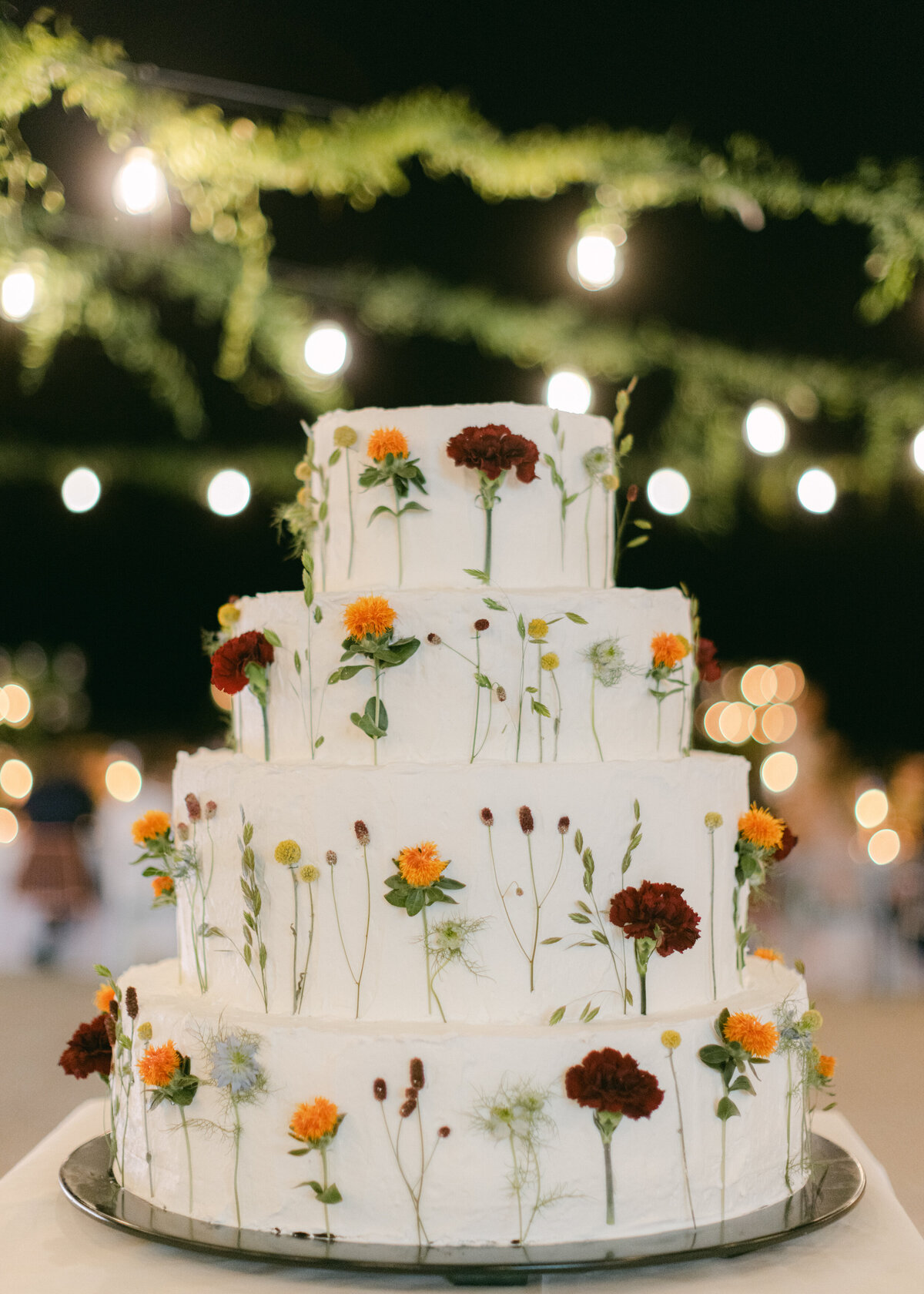 full-stemmed flowers on wedding cake