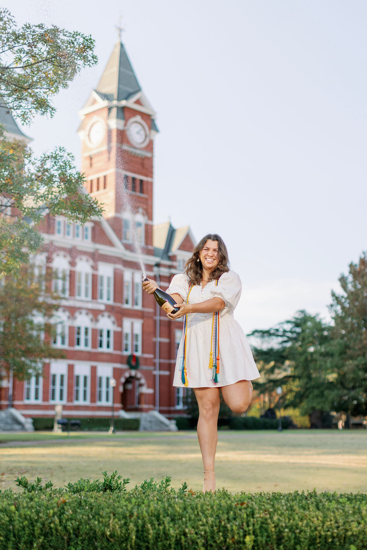 Auburn graduate popping champagne