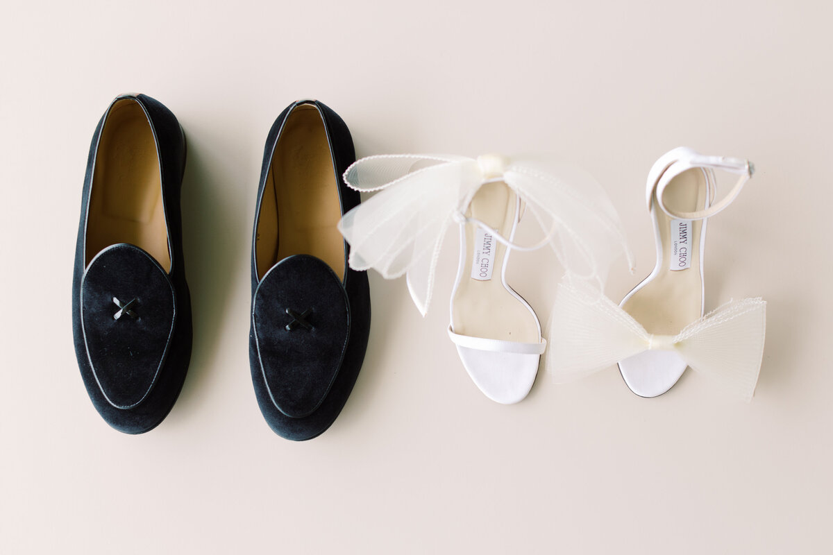 Iconic bridal shoes and groom’s velvet loafers, a perfect pair for a refined wedding.