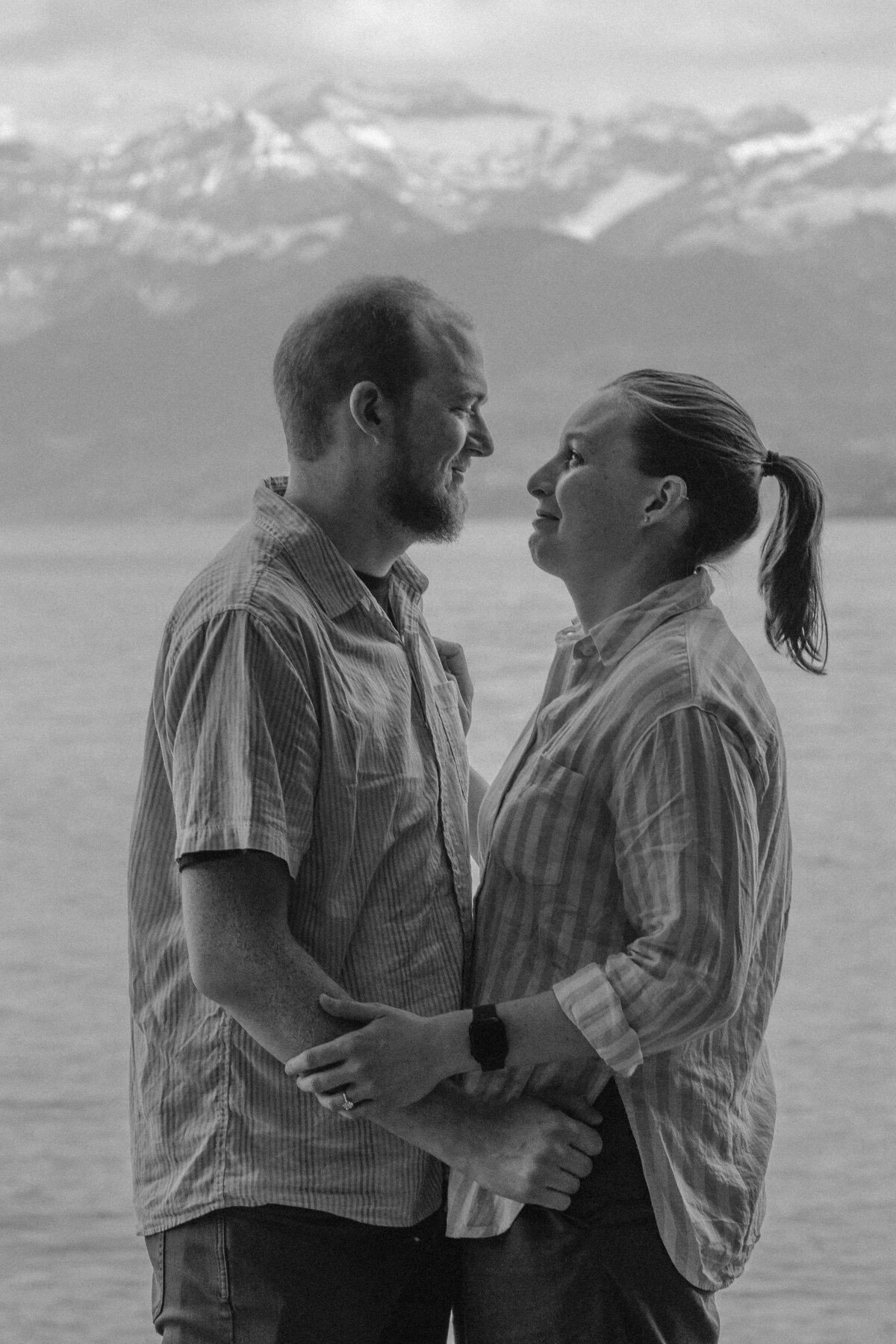 A couple standing close and smiling at each other