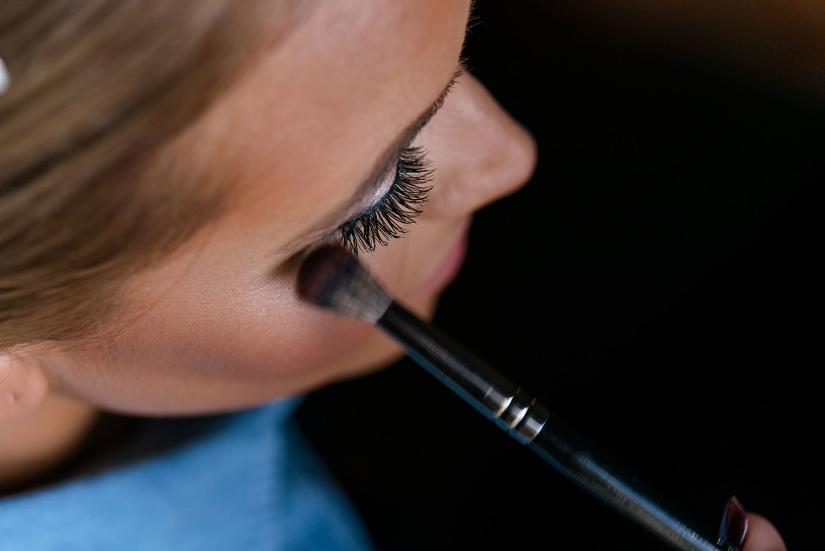 Bride getting her makeup done at The Inn at Fox Hollow