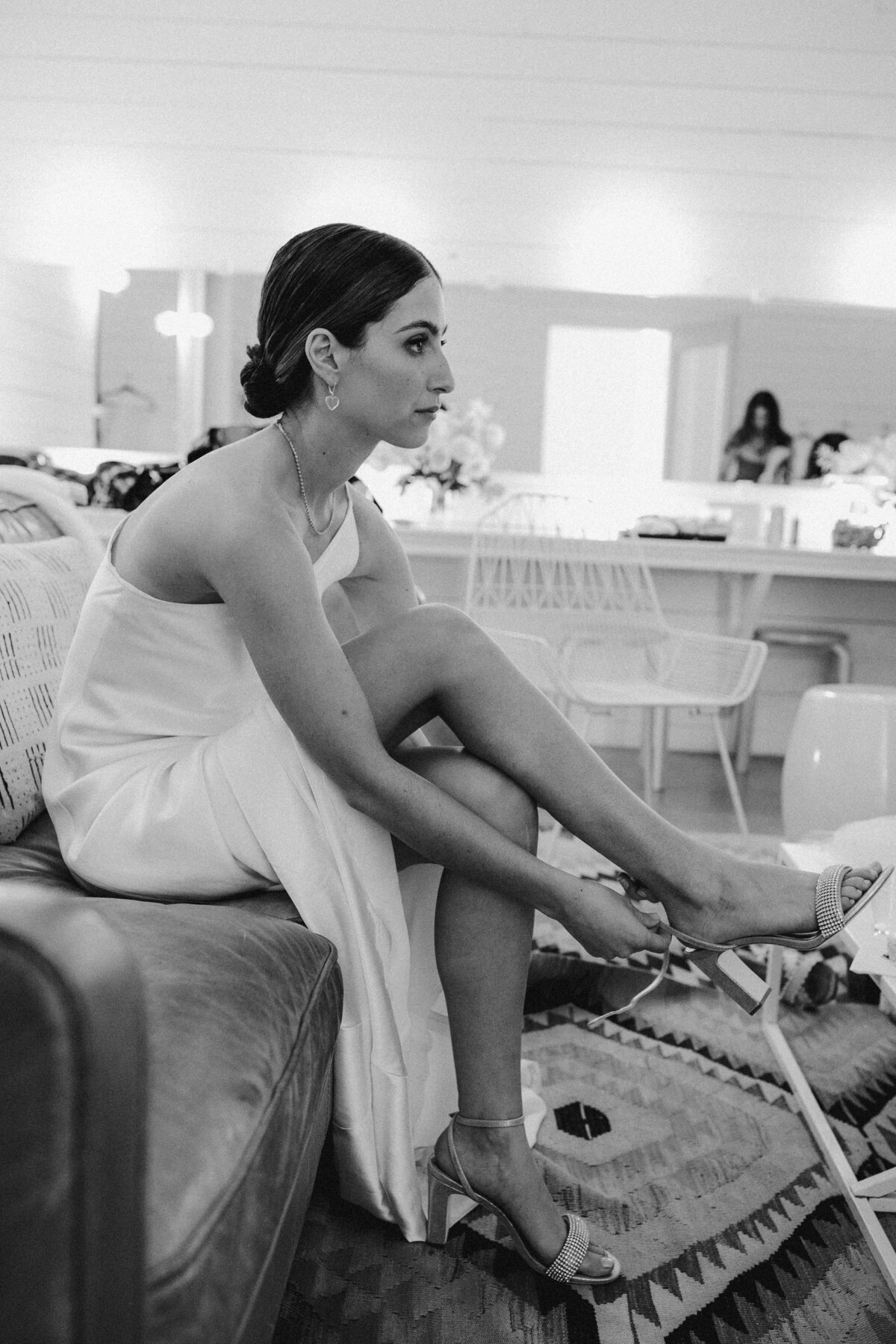 Bride putting on shoes for wedding at Prospect House, Austin