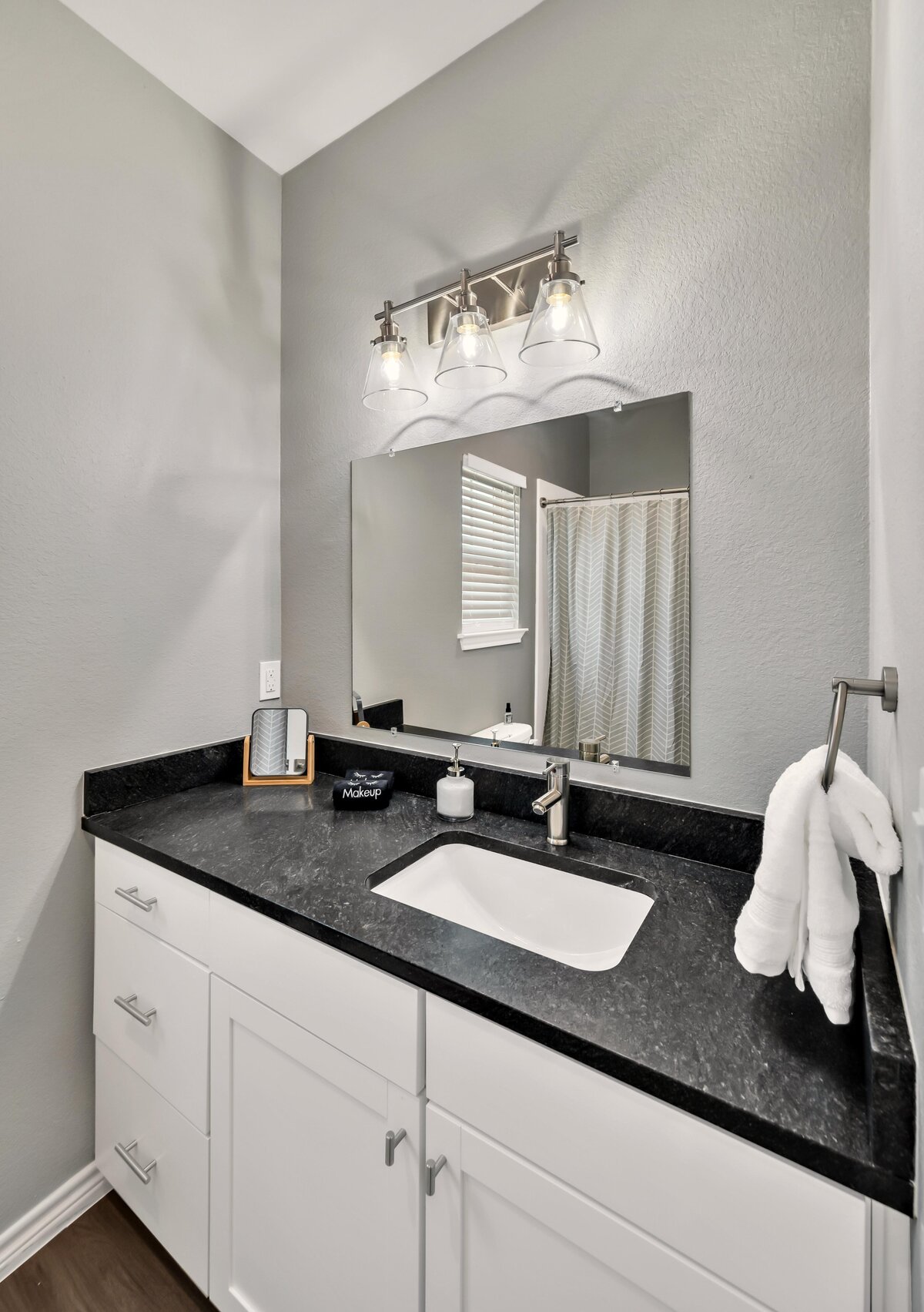 Large bathroom vanity in the bathroom of this four-bedroom, 4.5 bathroom new construction vacation rental house with free wifi, fire pit, gazebo, cornhole, private bathrooms for each bedroom within walking distance of Magnolia and Baylor in downtown Waco, TX.