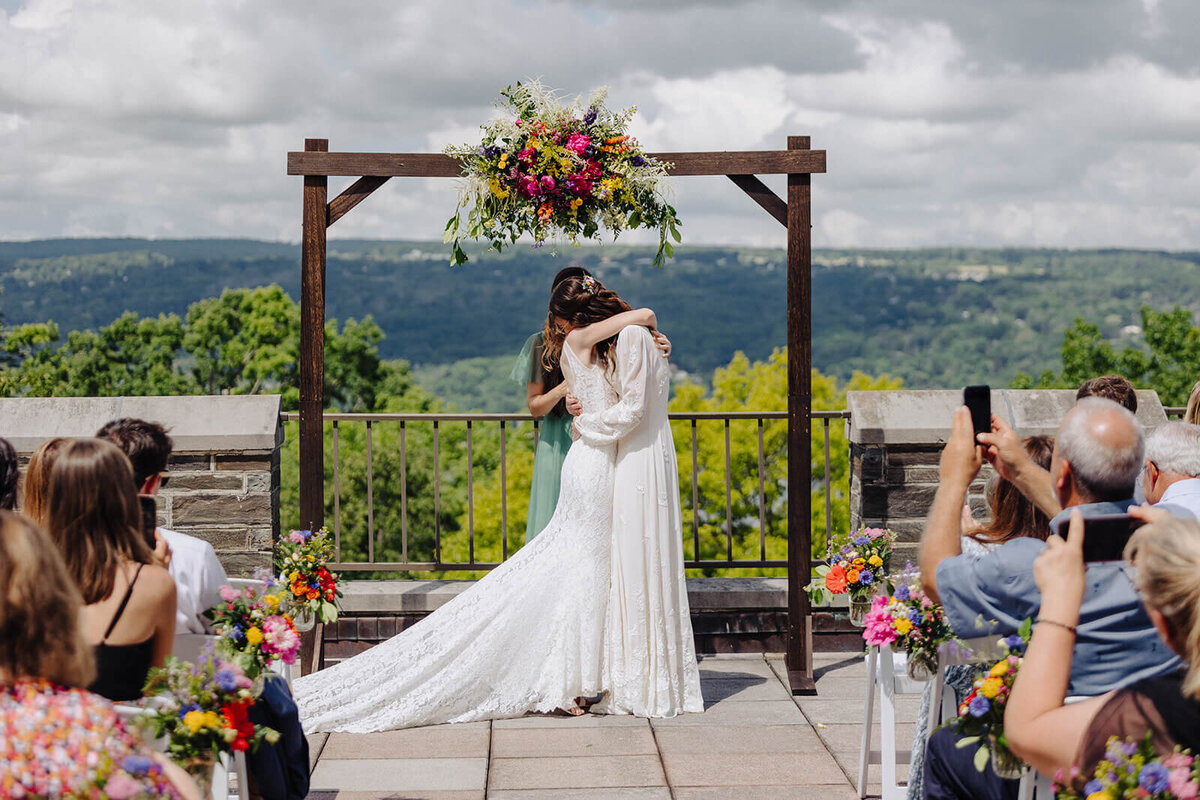 two brides kissing after wedding ceremony at Cornell University