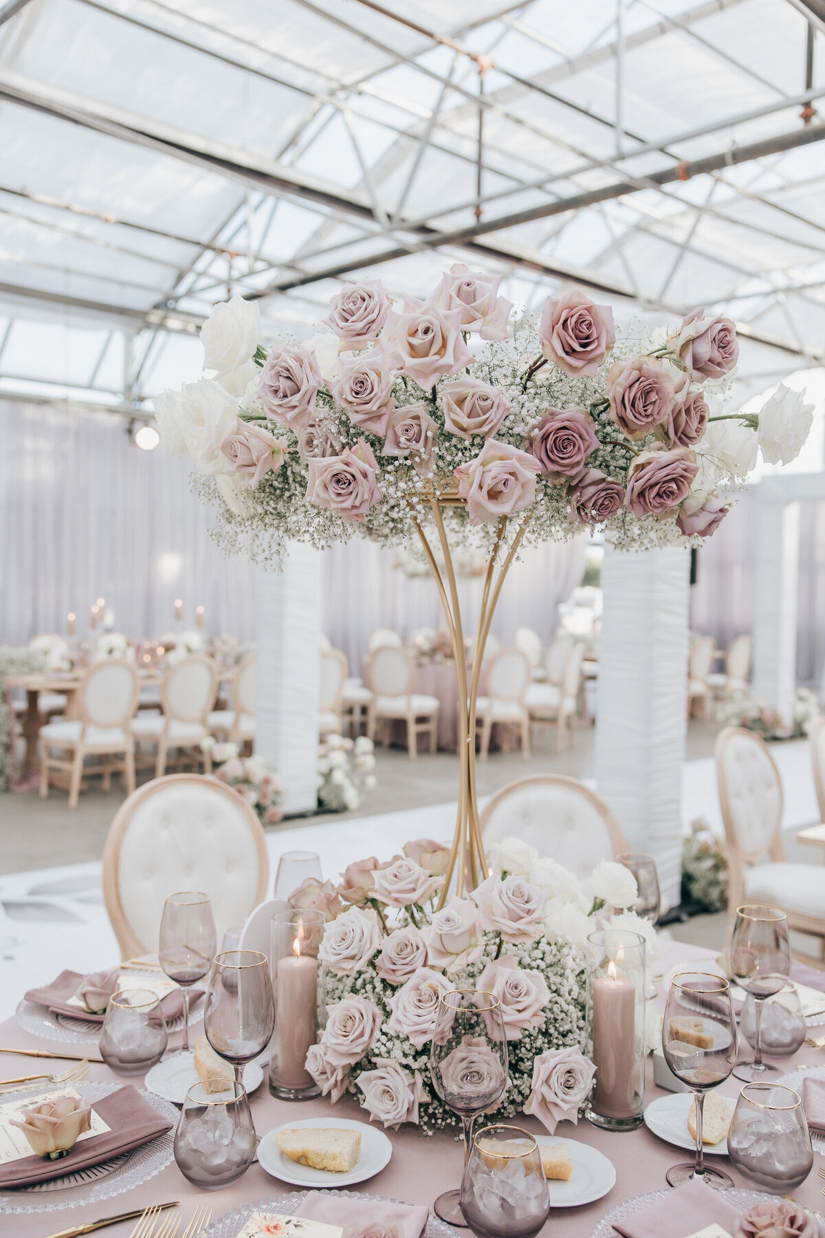 Luxurious wedding table centre pieces with pink roses and baby's breath