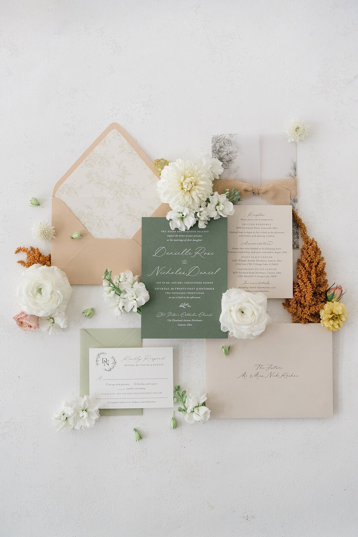 Columbus wedding  photographer captures wedding invitations and florals laid out for a wedding detail photo