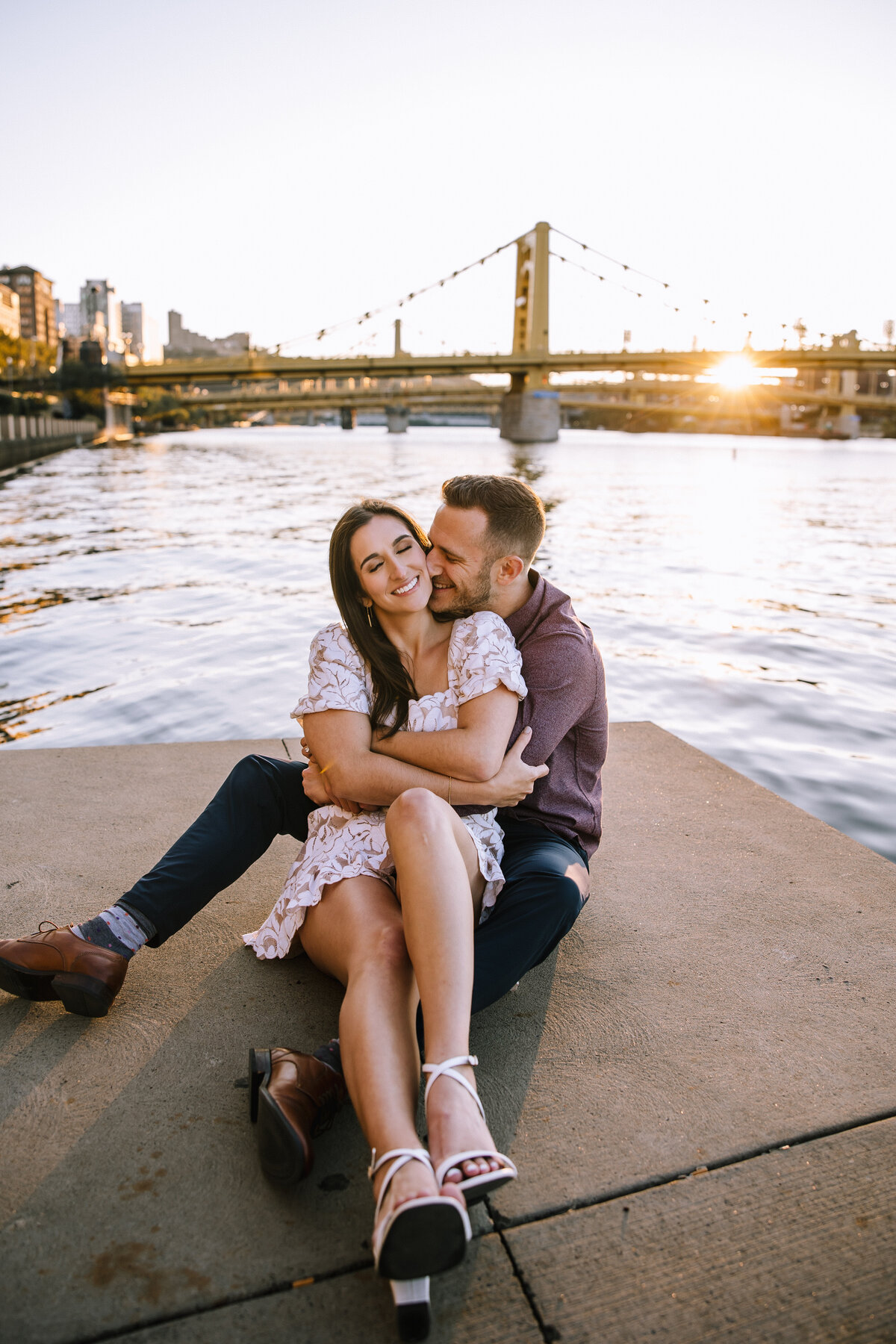 Engaged couple on the Pittsburgh north shore by the water.