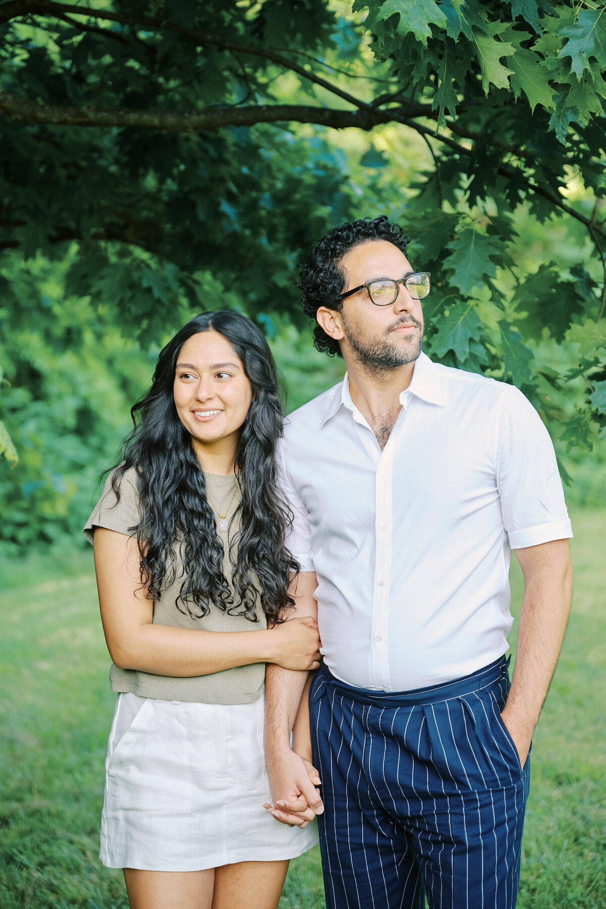 Couple stand face to face smiling after a successful New York City Picnic Proposal.  Photo taken by NYC Proposal Photographer, Corey Lamar Photography