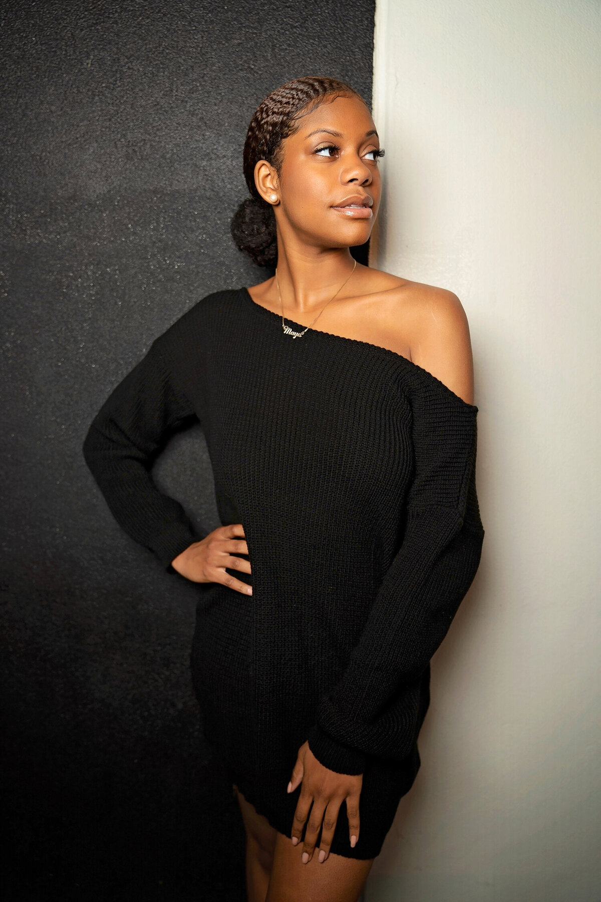 brown skin girl posing downtown against wall