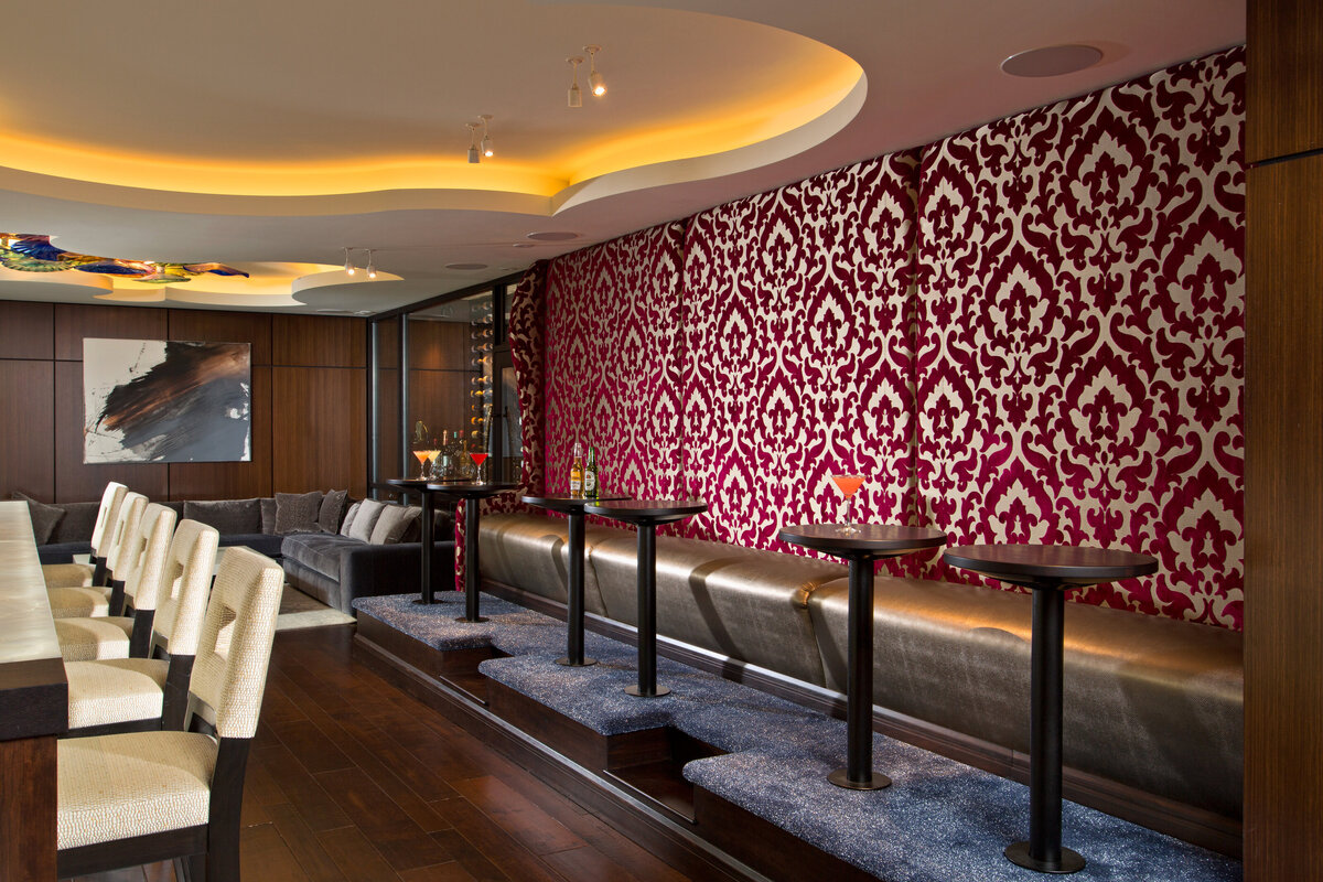 standup bar tables with red accent wallpapered wall