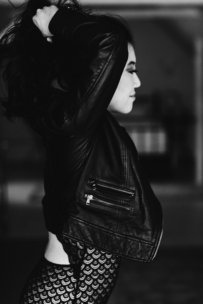 An edgy boudoir photo with a leather jacket