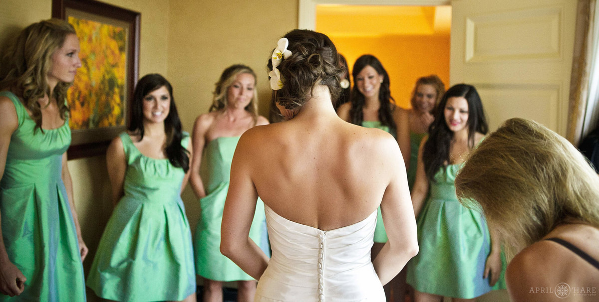 Bridesmaids look at bride in approval on her wedding day at the Ritz Carlton Hotel in downtown Denver Colorado