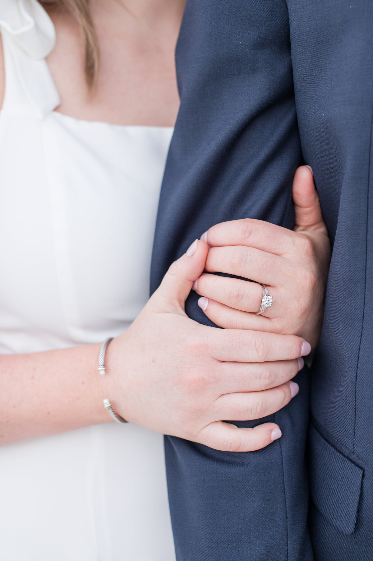 close up of hands and engagement ring