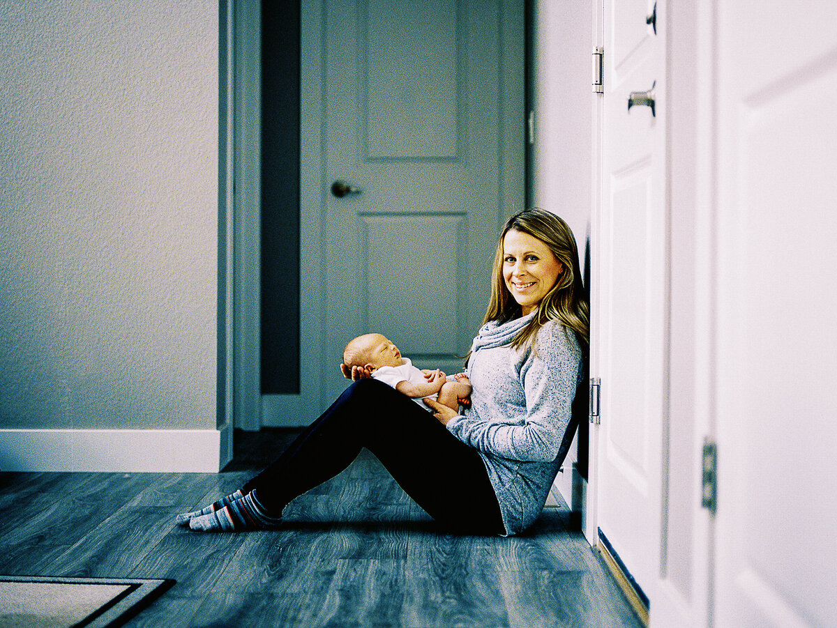 lifestyle newborn photo  of mom holding baby boy