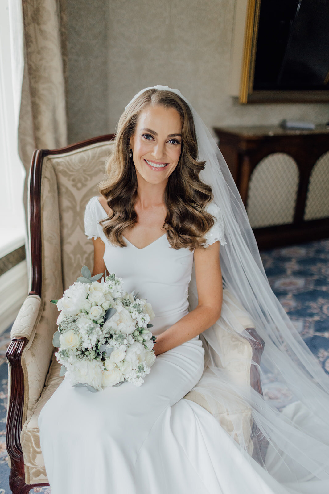 bride-posing-on-chair-for-photographs