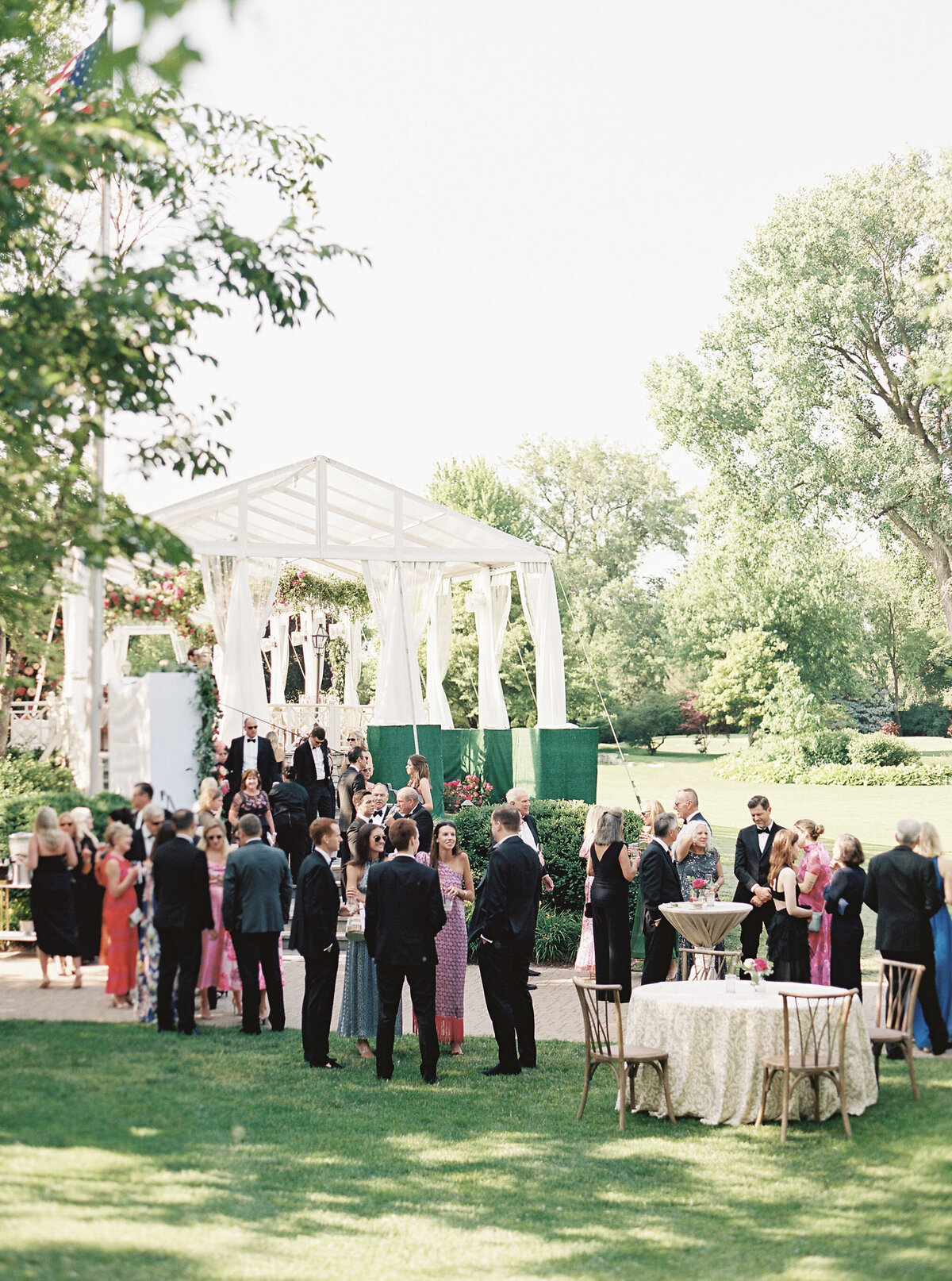 Guests mingling outdoors at a vibrant wedding reception.