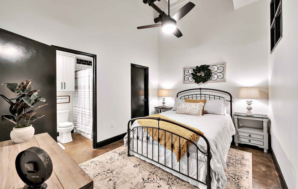Master bedroom with private bathroom in this industrial two-bedroom, two-bathroom first floor rental condo in the historic Behrens Building in downtown Waco, TX.