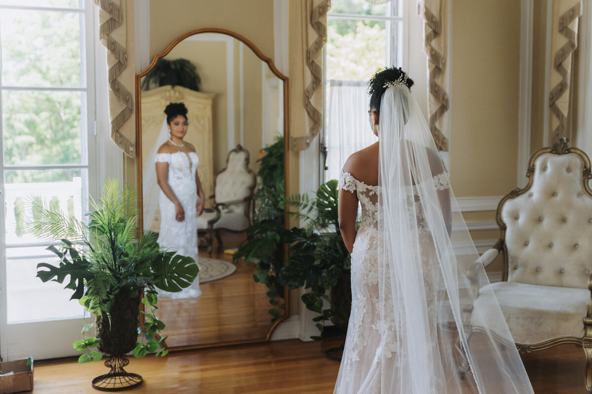 bride looking at her self in mirror - baltimore wedding photographer