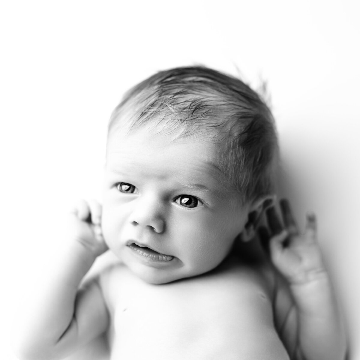 Awake, curious, and full of life—this black and white newborn portrait captures it all.